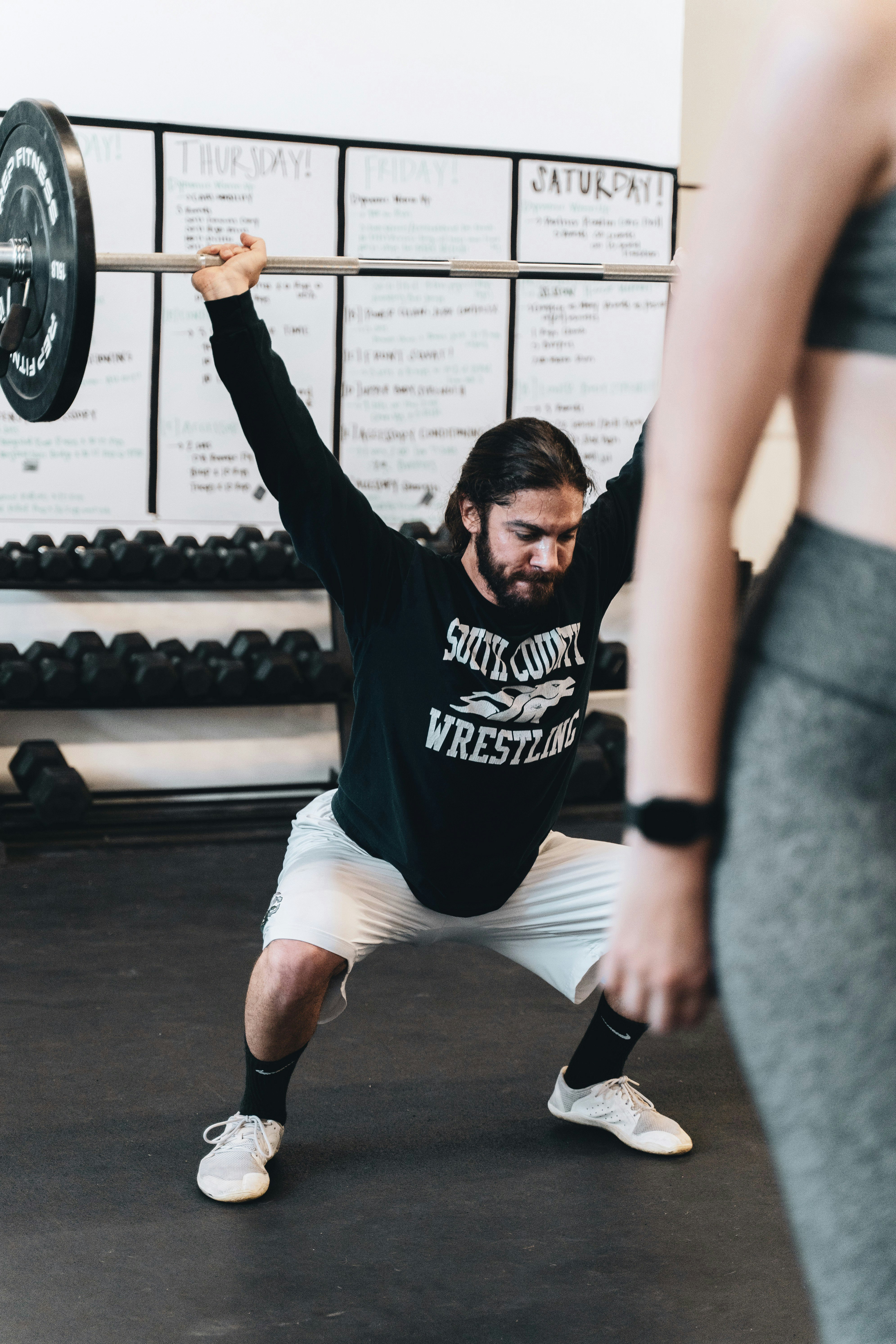 man in black and white crew neck t-shirt and white shorts doing exercise